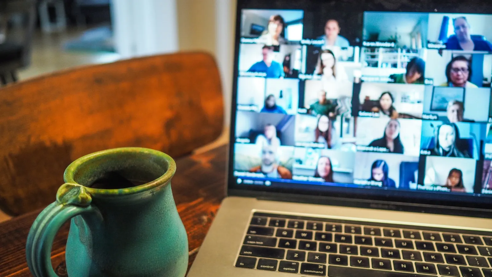 A laptop showing a video call with a grid of remote team members